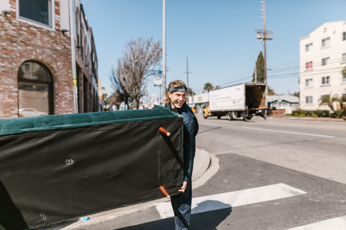 SwiftHaul Moving crew carefully loading protected furniture into a moving truck