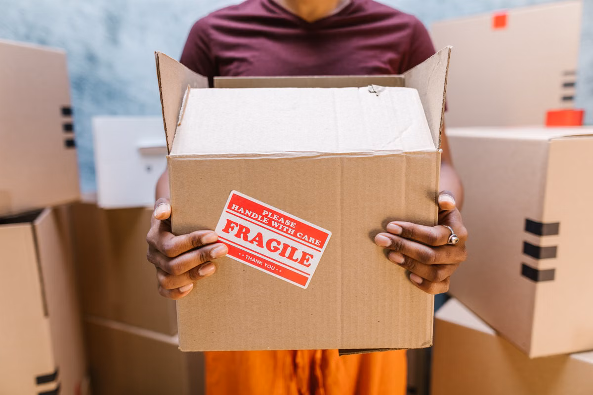 SwiftHaul Moving crew carrying labeled boxes through a Philadelphia apartment
